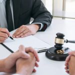 Agreement prepared by lawyer signing decree of divorce (dissolution or cancellation) of marriage, husband and wife during divorce process with male lawyer or counselor and signing of divorce contract